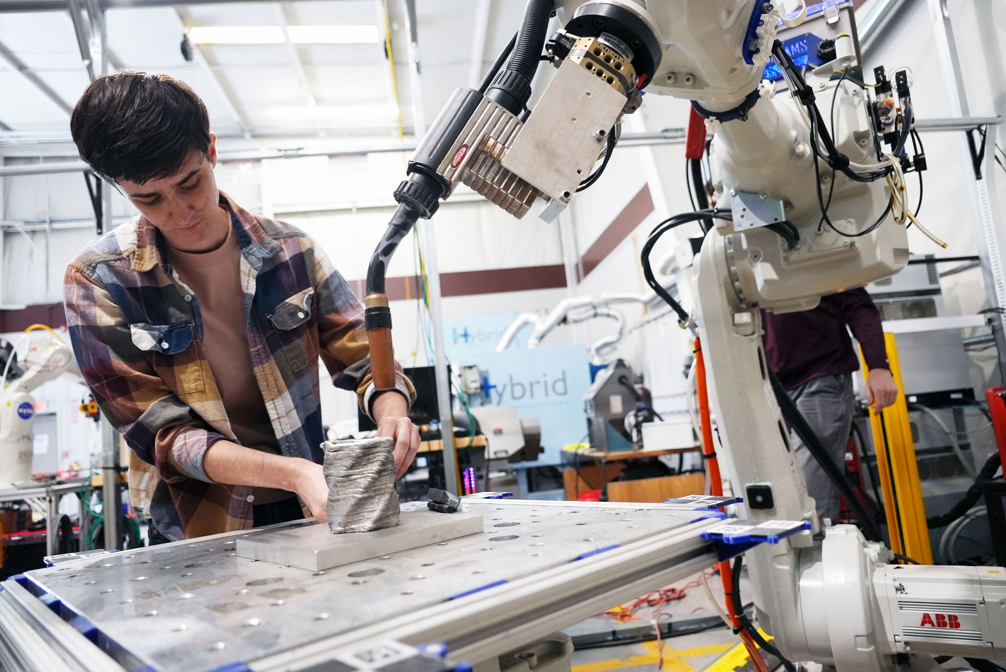 A student works with a directed energy deposition printer in the DREAMS Lab. Photo by Alex Parrish for Virginia Tech.
